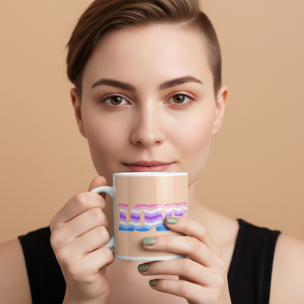 Person holding a white mug with LOVE in pastel genderfluid flag colors