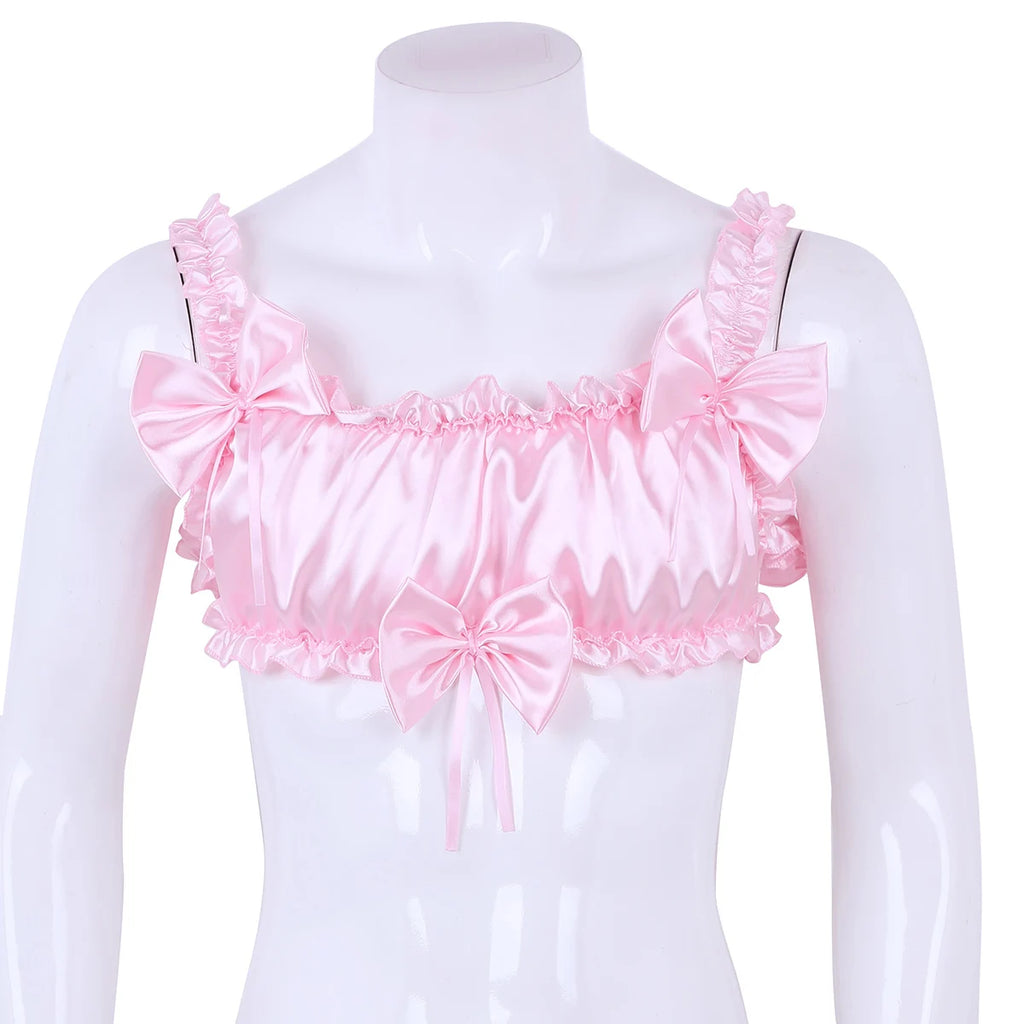Front view of a pink satin crop top on a mannequin, with ruffles and three large bows