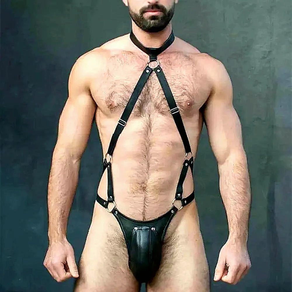 Front-view model wearing a black leather chest harness and pouch thong