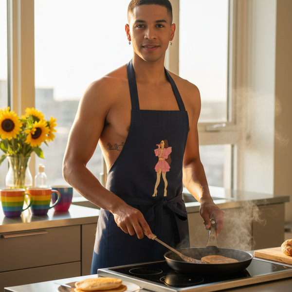 Person wearing a dark apron with a pink singer graphic flips a pancake in a sunlit kitchen