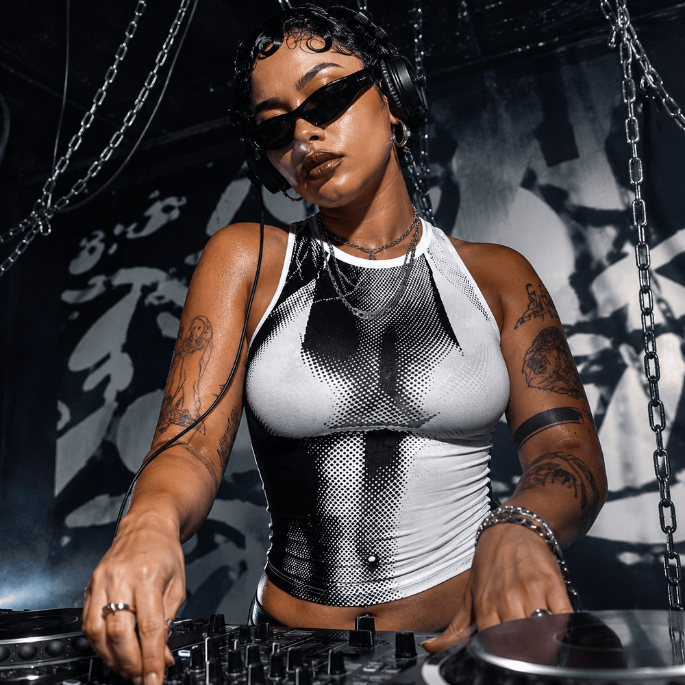 Model wearing a black-and-white anatomical heart tank top while DJing