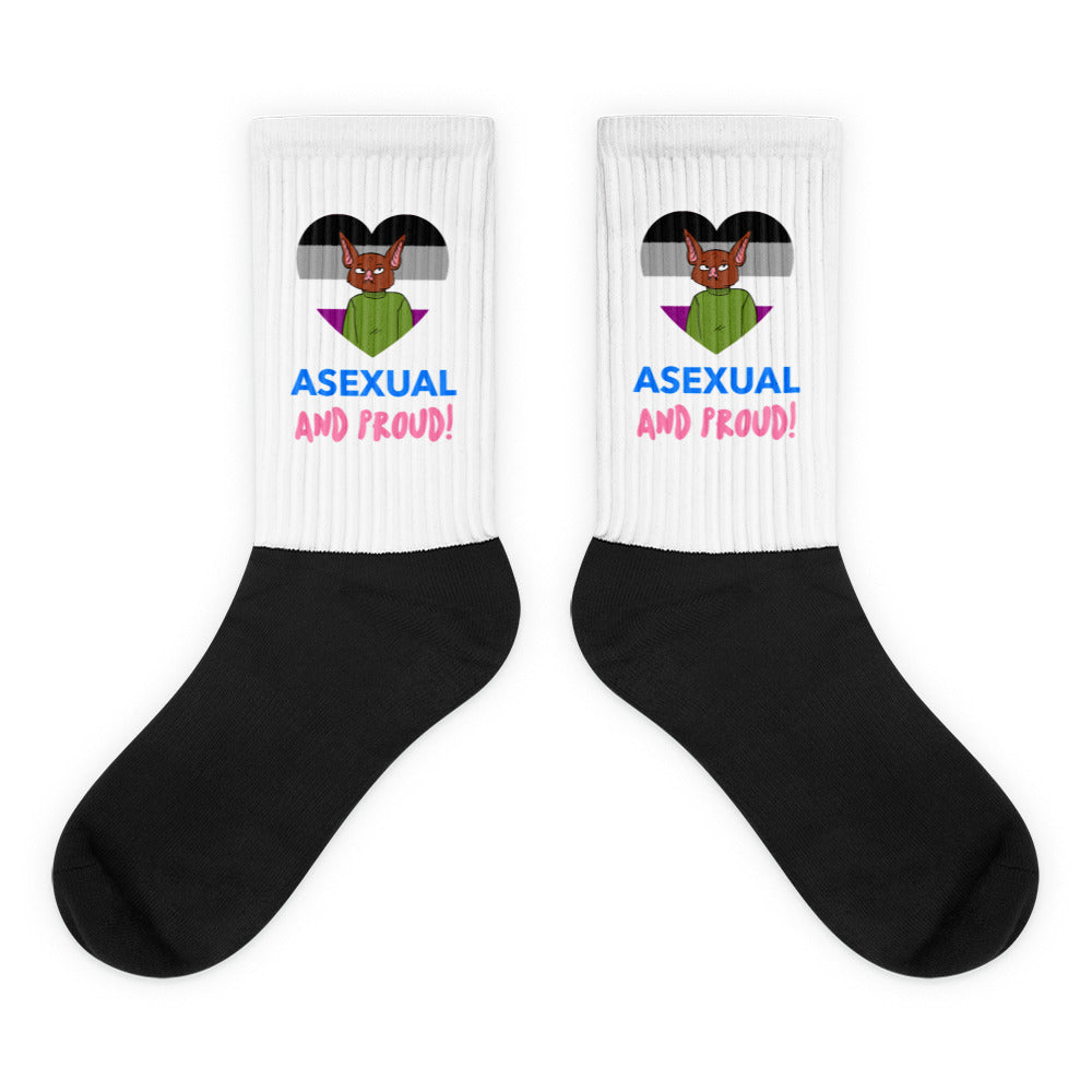 Pair of black-and-white crew socks reading “ASEXUAL AND PROUD!” with a cat over an ace flag