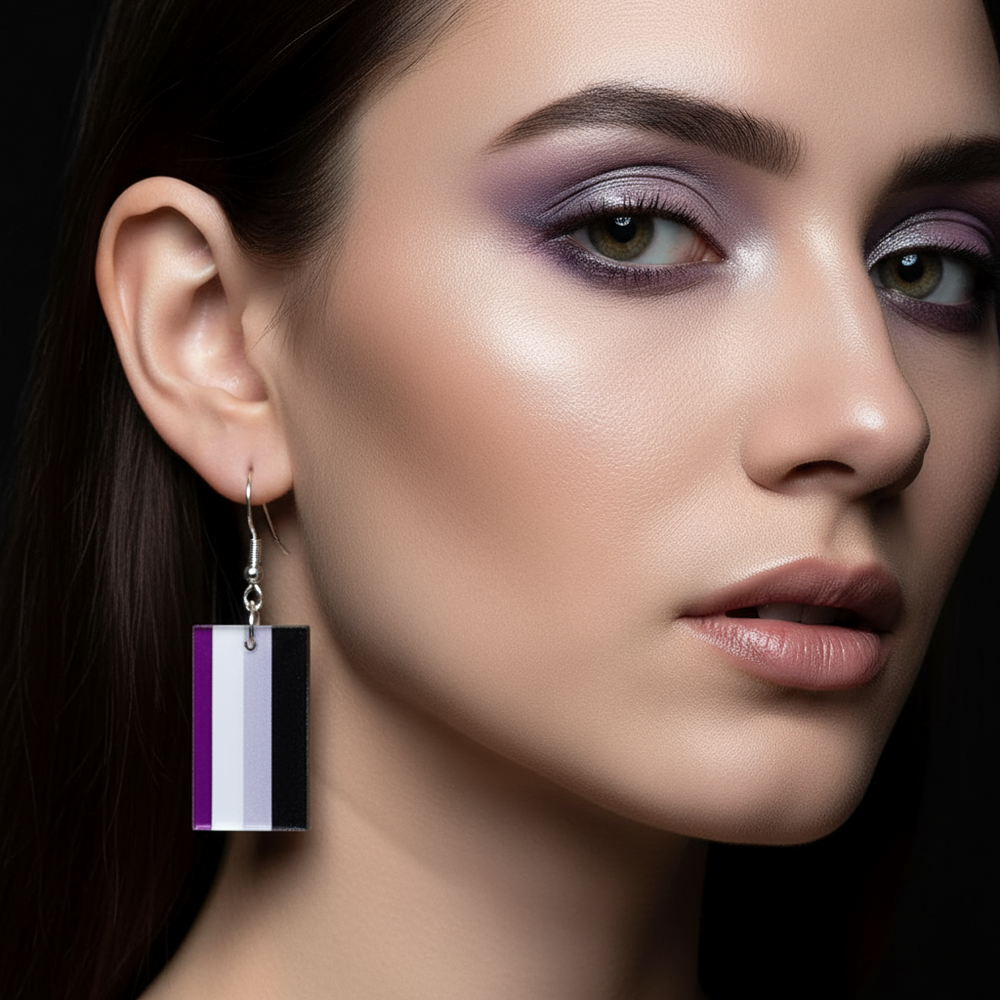 Close-up side view of a rectangular purple, white, gray, and black striped dangle earring on a model
