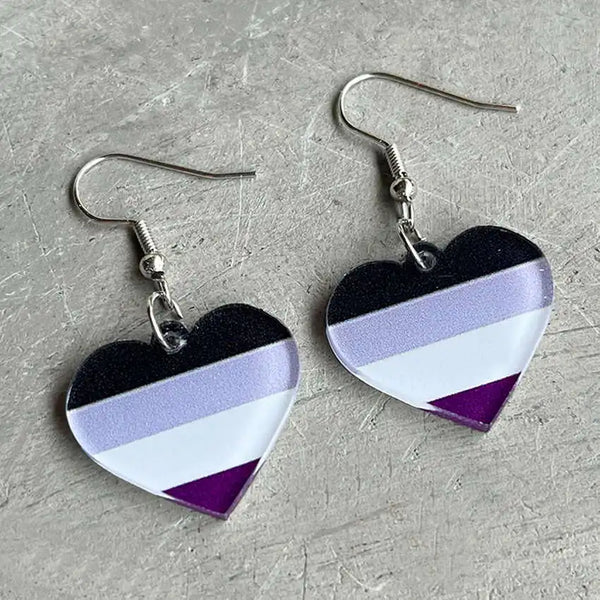 Pair of heart-shaped acrylic dangle earrings with black, lavender, white, and purple stripes