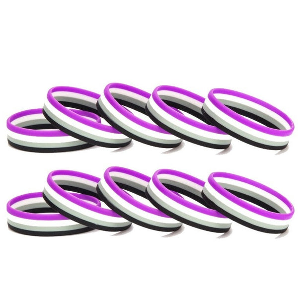 Ten black, gray, white, and purple rubber wristbands arranged in two rows