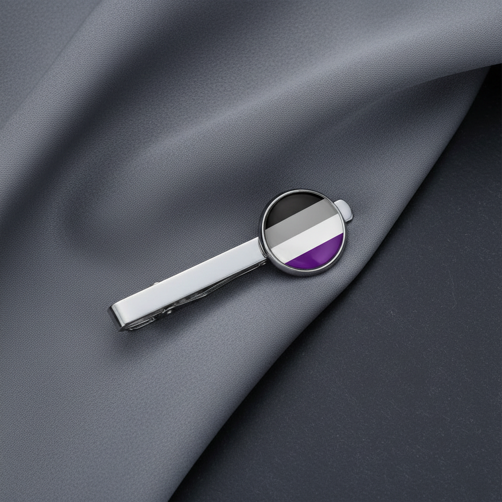 Asexual Pride tie clip with a round emblem displays black, gray, white