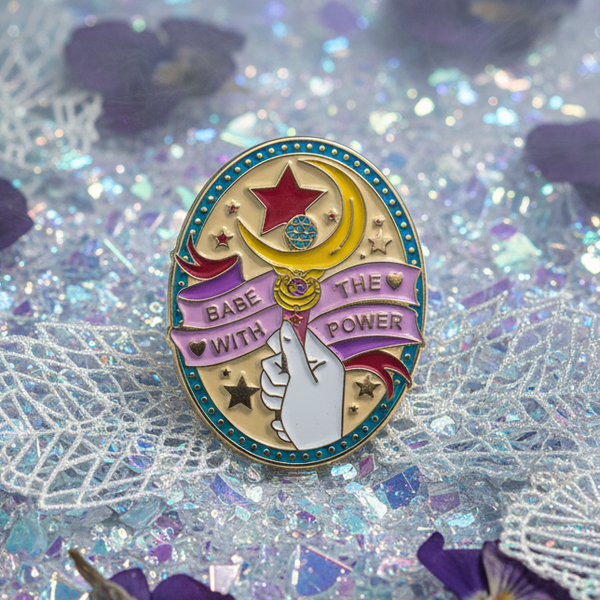 Enamel pin reading “Babe With the Power,” with a raised fist, star and crescent design