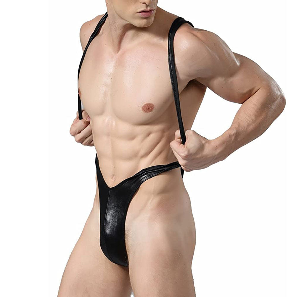 Front three-quarter view of a shirtless model wearing a black leather-look slingshot swimsuit