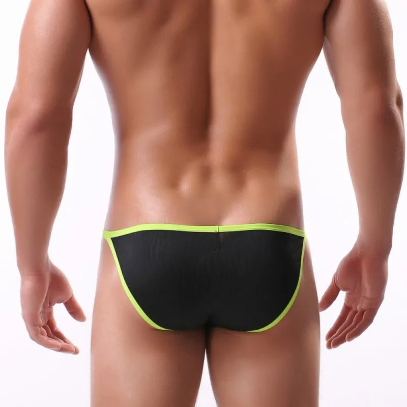 Rear view of a model wearing black briefs with bright lime-green trim