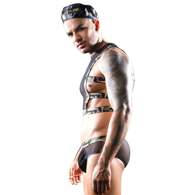 Side-view model wearing a camouflage bondage-style harness and briefs with a cap