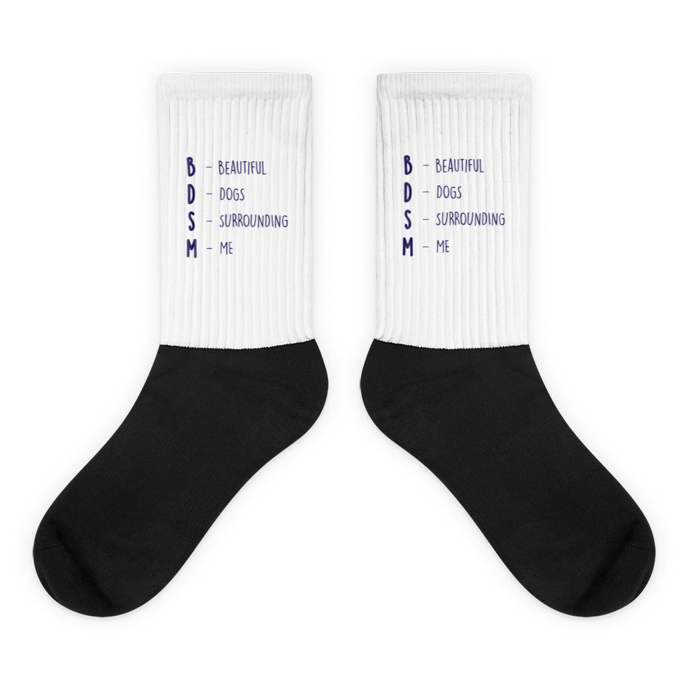 Pair of black-and-white socks reading “BDSM – Beautiful Dogs Surrounding Me”
