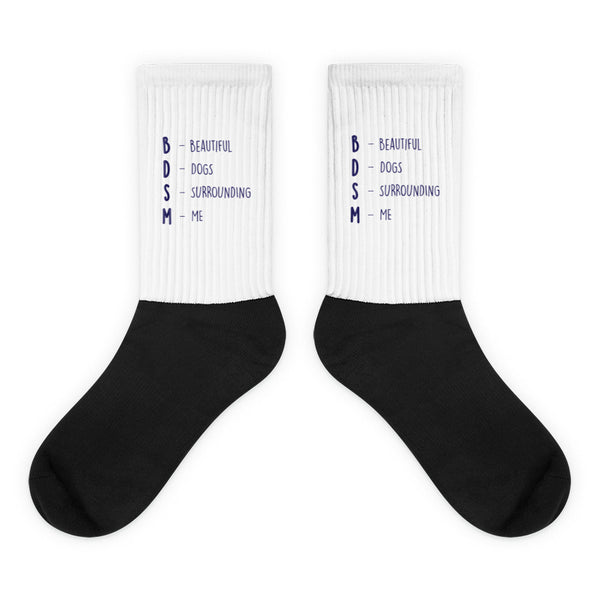 Pair of black-and-white socks reading “BDSM – Beautiful Dogs Surrounding Me”