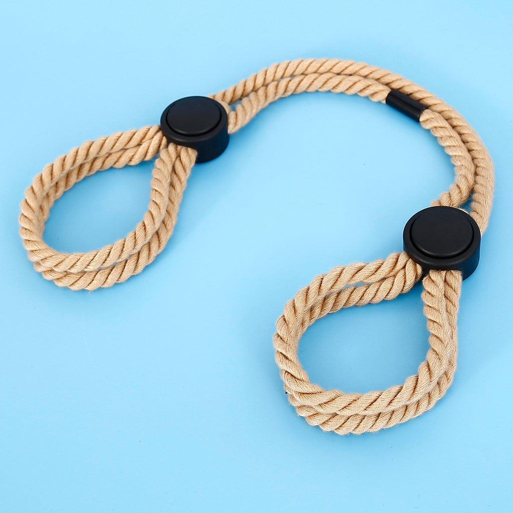 Tan twisted rope restraints with black round connectors arranged on a blue background