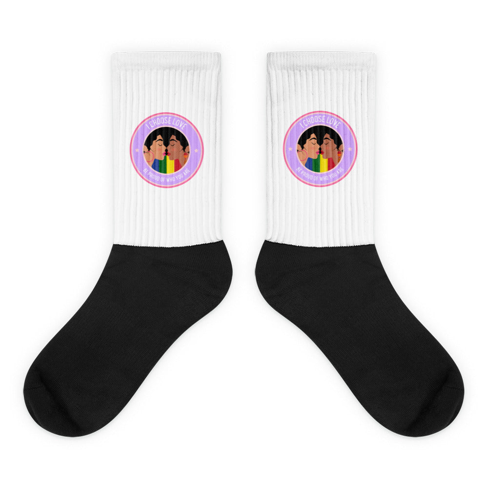 Pair of black-and-white ribbed socks with colorful kissing-faces badges and pride wording
