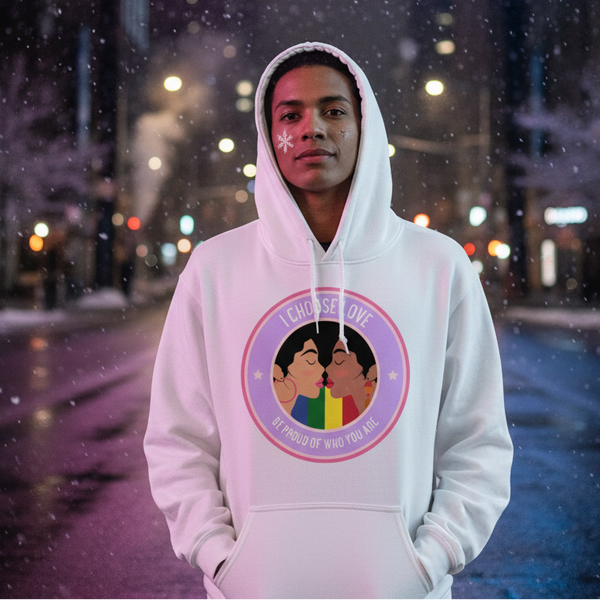 Person in a white hoodie with two illustrated faces kissing over a rainbow, standing in falling snow