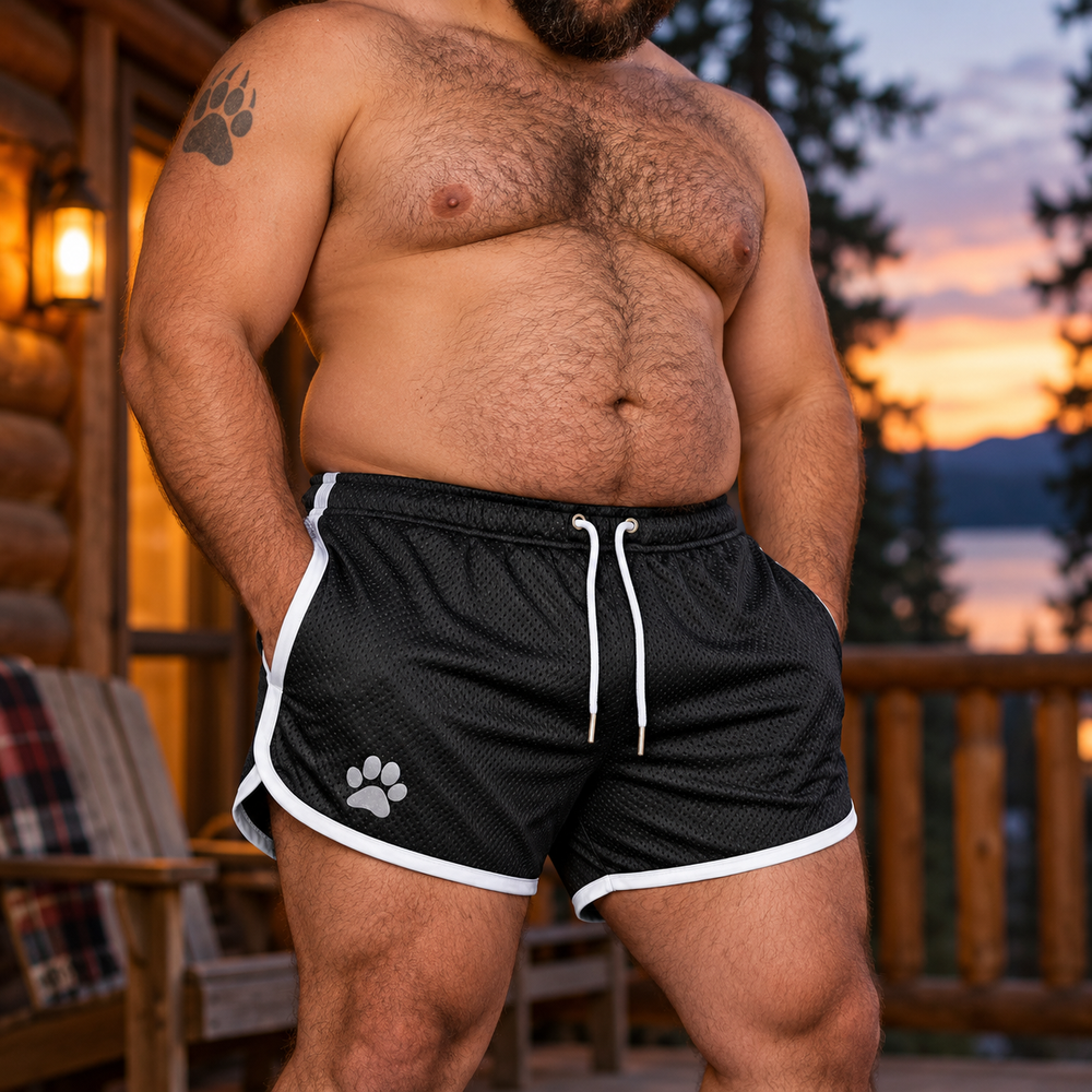 Bear Pride Paw Shorts — Midnight Cub worn by a model.