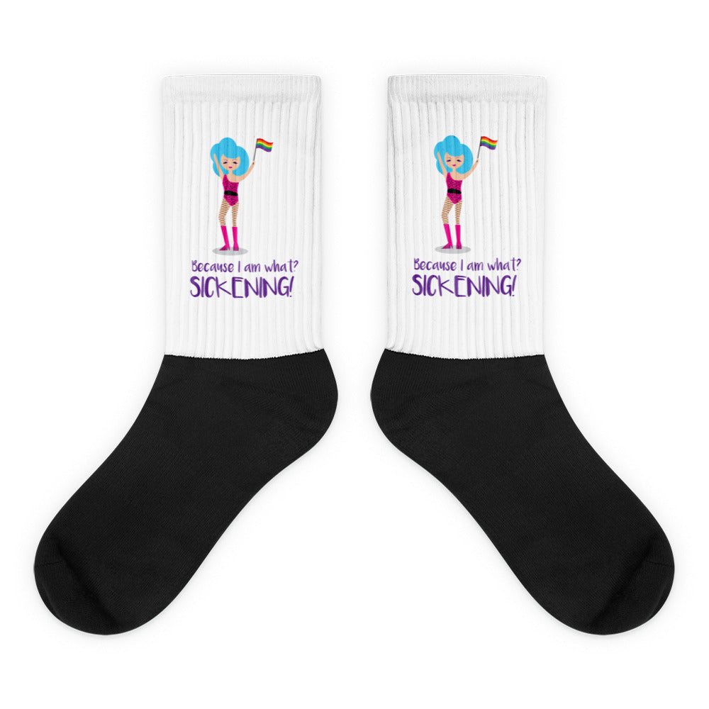 Pair of black-and-white crew socks with a cartoon figure and Pride flags, reading “Because I am what? SICKENING!”