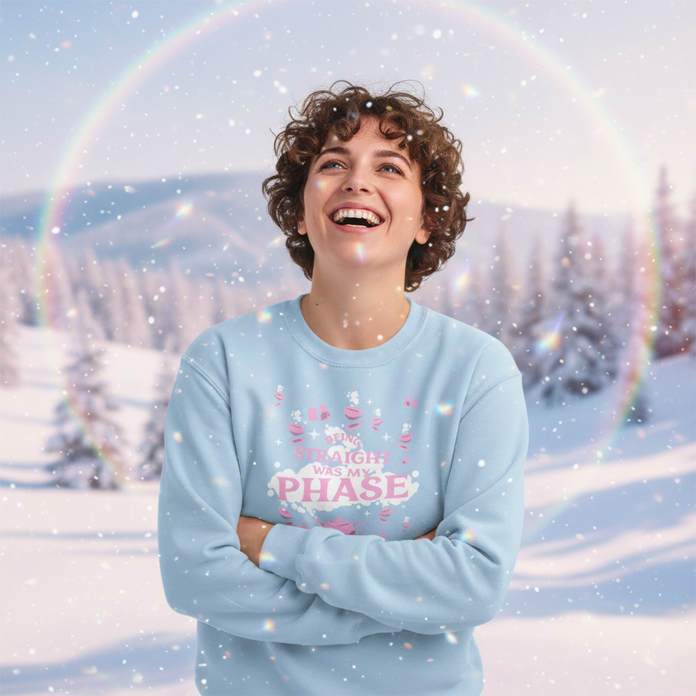 Smiling person in a light blue sweatshirt reading “Being Straight Was My Phase”
