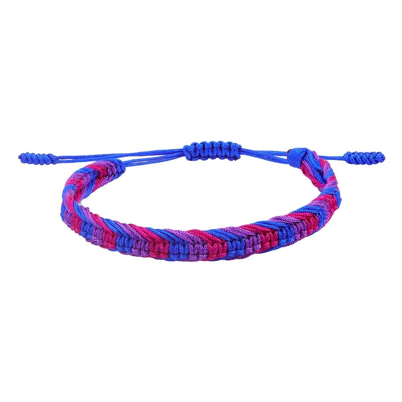 Close-up of a braided blue, pink, and purple adjustable bracelet on white