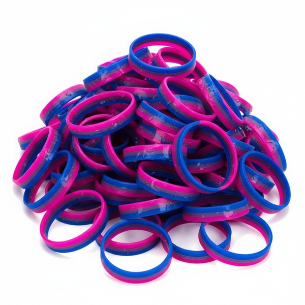 Pile of pink, purple, and blue rubber wristbands on a white background