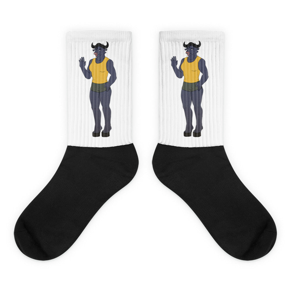 Pair of crew socks with black feet and white ribbed cuffs featuring a waving horned figure