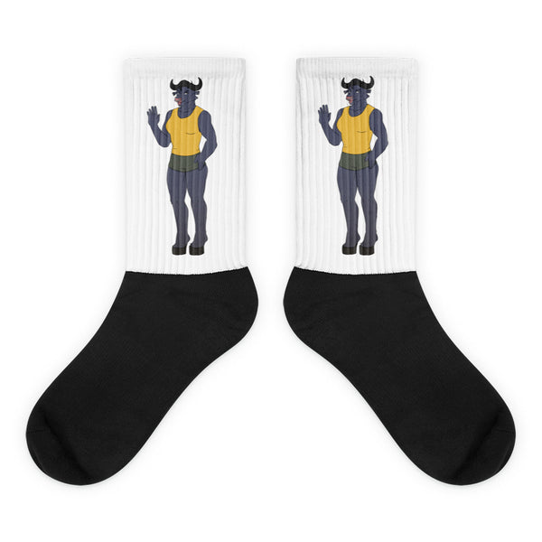 Pair of crew socks with black feet and white ribbed cuffs featuring a waving horned figure