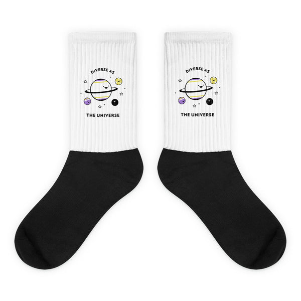 Pair of black-and-white socks with a space graphic and “DIVERSE AS THE UNIVERSE” text