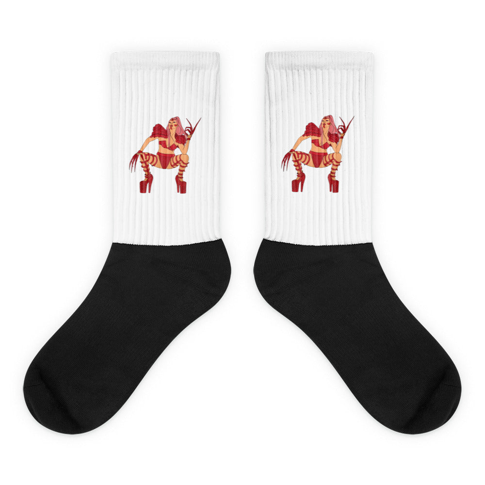 Pair of black-and-white crew socks with red illustrated figures on the ribbed cuffs