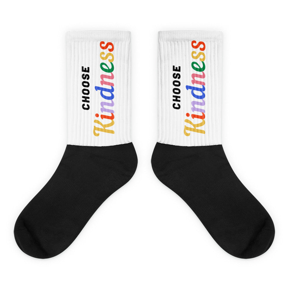 Pair of black-and-white socks with rainbow “CHOOSE Kindness” text on the cuffs