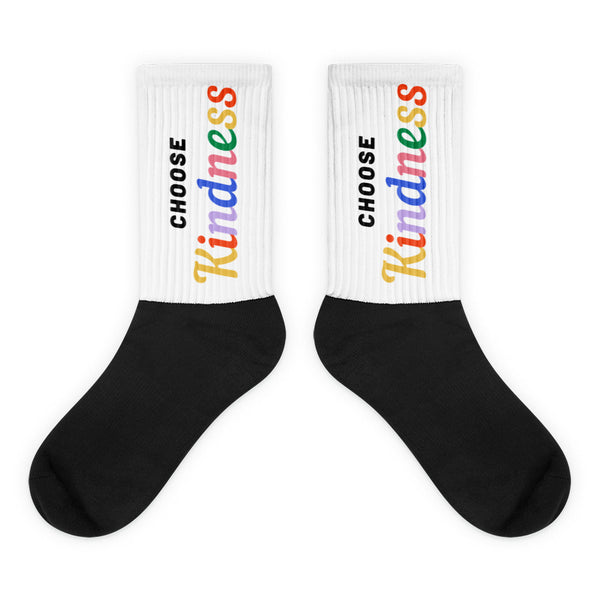 Pair of black-and-white socks with rainbow “CHOOSE Kindness” text on the cuffs