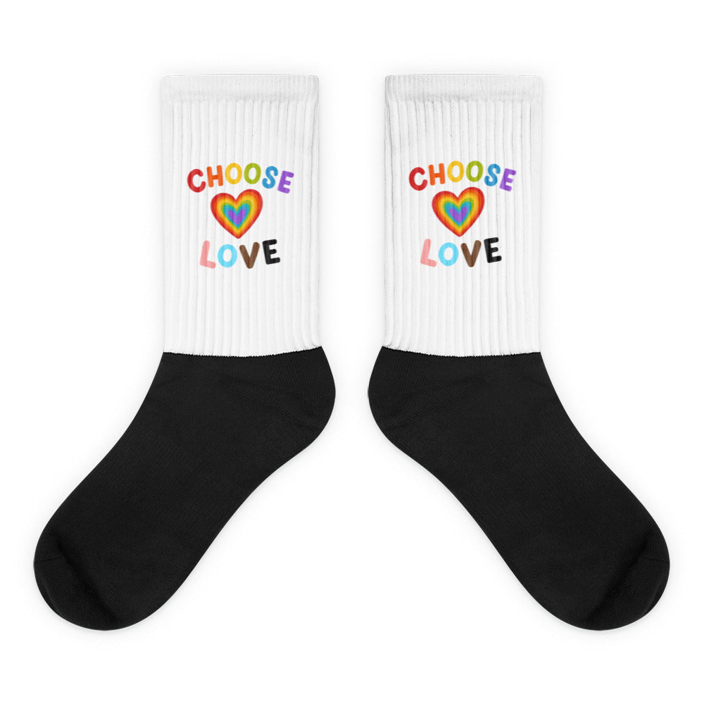 Pair of black and white ribbed socks with rainbow heart and “CHOOSE LOVE” text