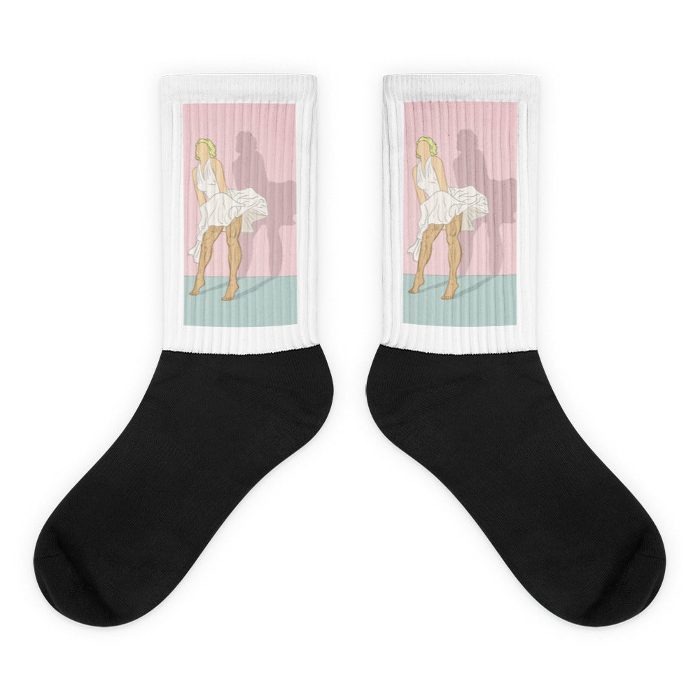 Pair of black socks with a pink-and-teal Marilyn Monroe-style dress-lifting illustration