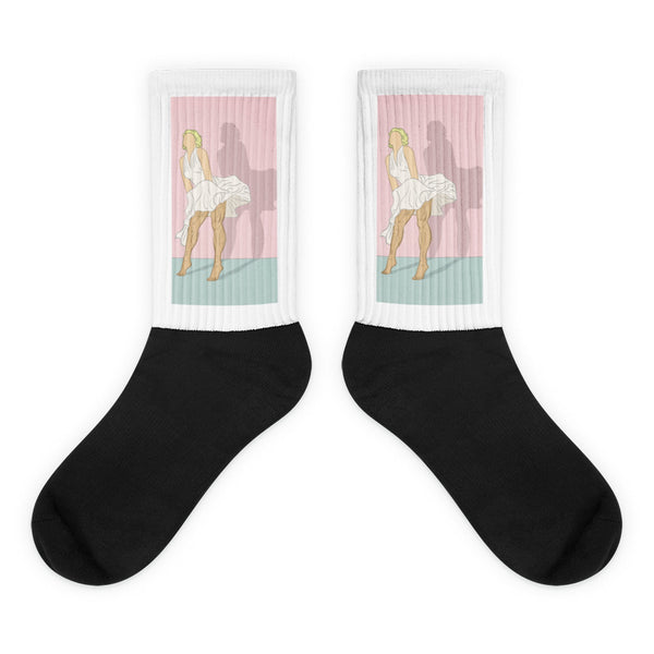 Pair of black socks with a pink-and-teal Marilyn Monroe-style dress-lifting illustration