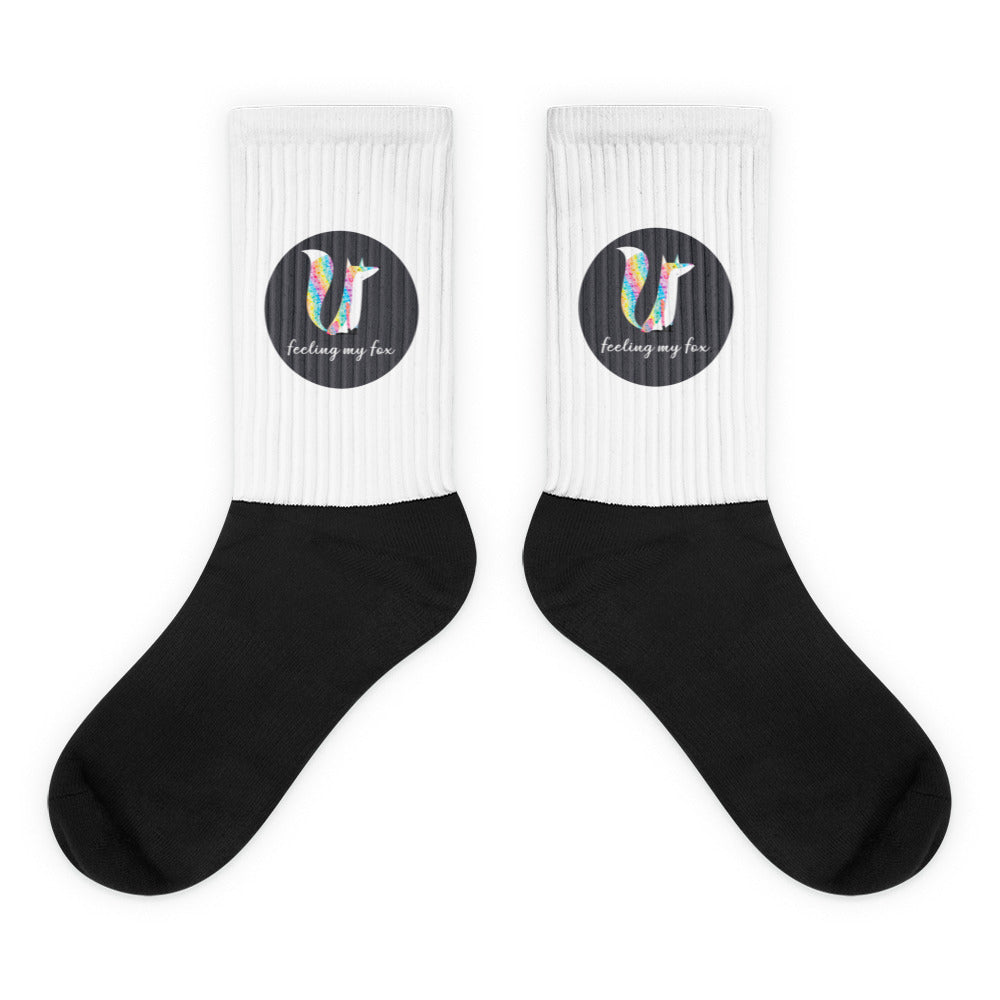 Pair of black and white ribbed socks with colorful fox graphics and “feeling my fox” text