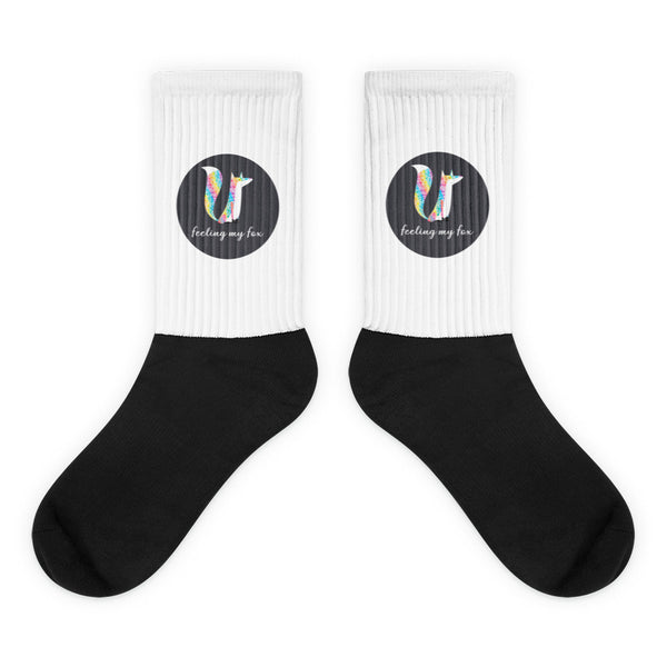 Pair of black and white ribbed socks with colorful fox graphics and “feeling my fox” text
