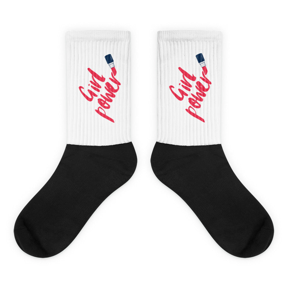 Pair of white and black socks with red “Girl Power” lettering and lipstick graphics
