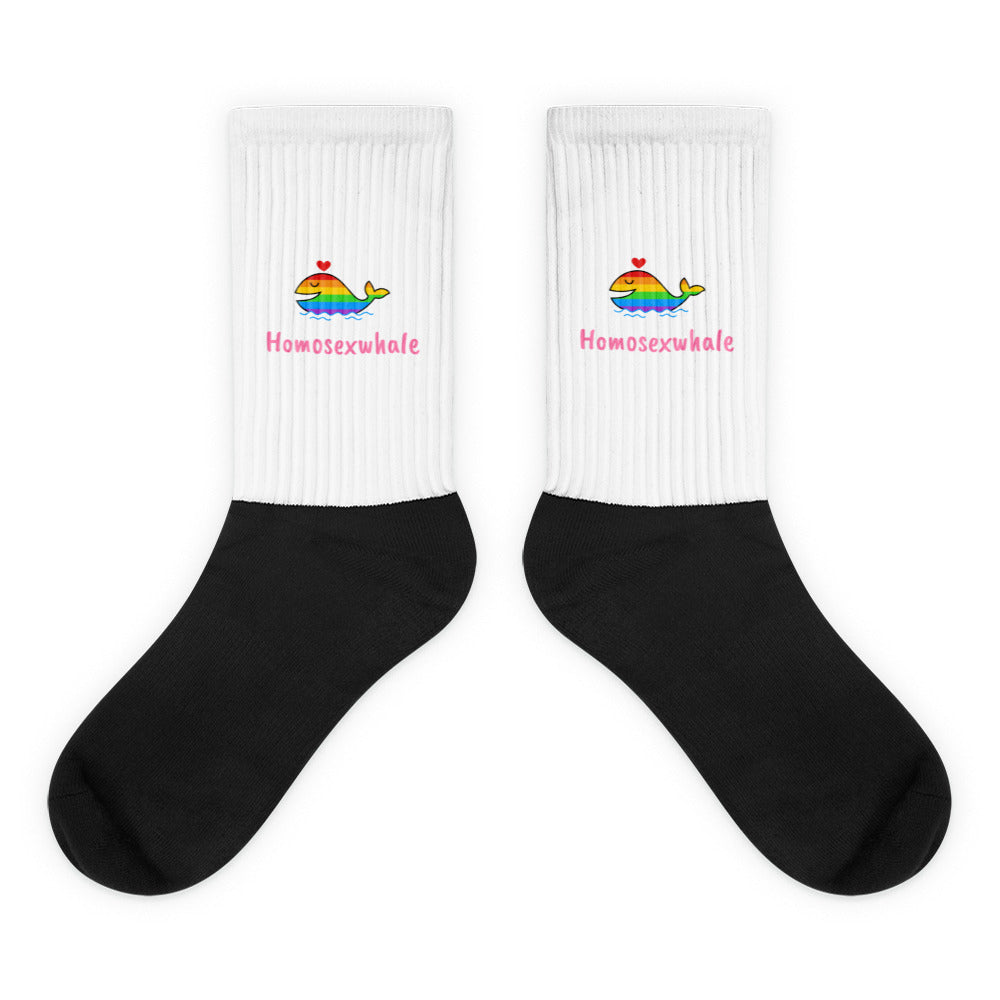 Pair of black-and-white crew socks with rainbow whales and “Homosexwhale” text