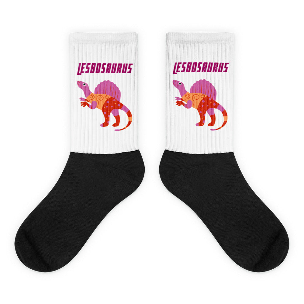 Pair of black-and-white socks with colorful dinosaurs and “LESBOSAURUS” on the cuffs