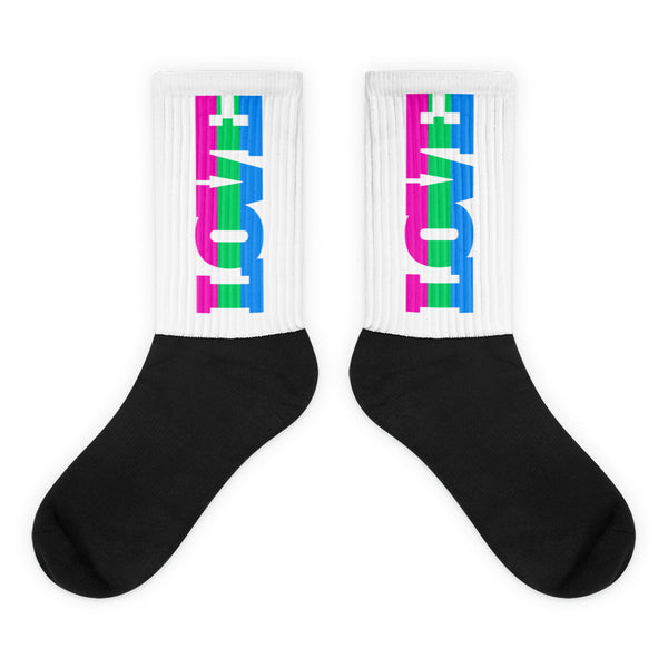 Pair of black-and-white ribbed socks with pink, green, and blue vertical graphics