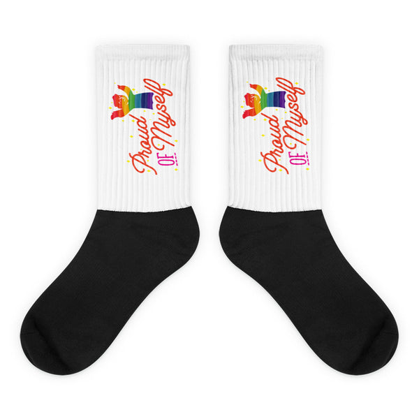Pair of black-and-white crew socks with rainbow cat graphics and “Proud Of Myself” text