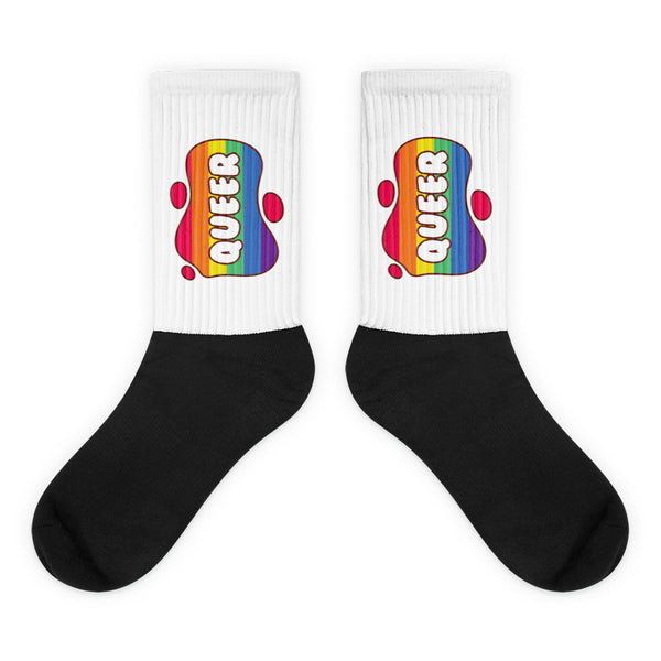 Queer Socks: Crew-length socks with a white ribbed top, black foot, and vibrant rainbow-striped QUEER graphic on the ankle, embodying bold, inclusive queer pride and self-expression.