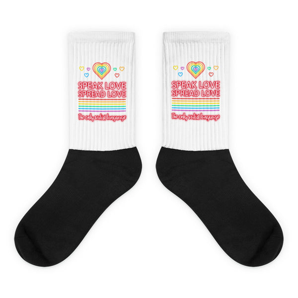 Pair of black-and-white crew socks with rainbow hearts and “SPEAK LOVE SPREAD LOVE” text