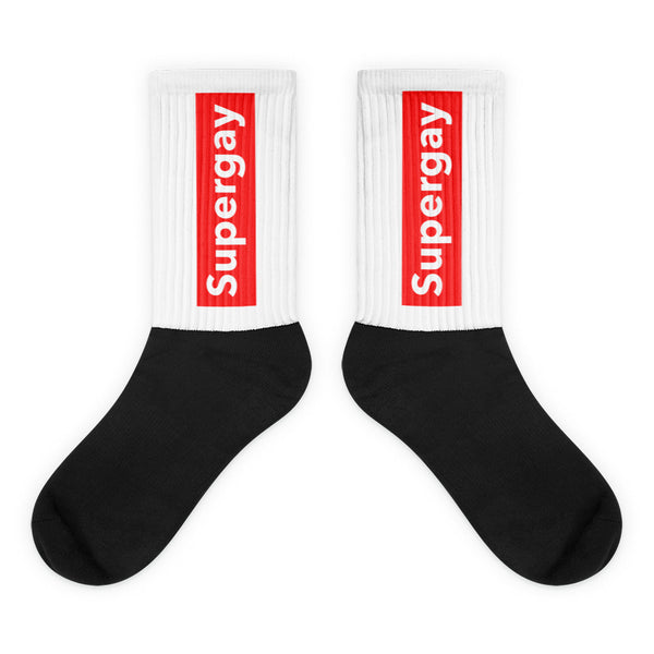 Pair of black-and-white crew socks with red vertical “Supergay” labels