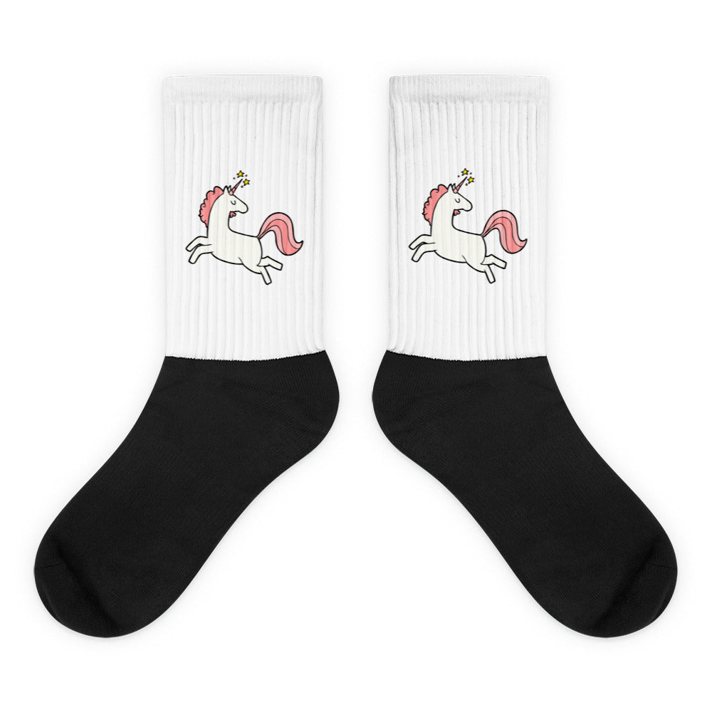 Pair of crew socks with white ribbed cuffs, leaping unicorns, and black feet