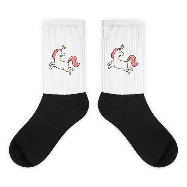 Crew-length Unicorn Socks featuring a white ribbed leg with a leaping unicorn motif, and a bold black foot. Crafted from a nylon-cotton-spandex blend for comfort and flair, celebrating queer pride and visibility.