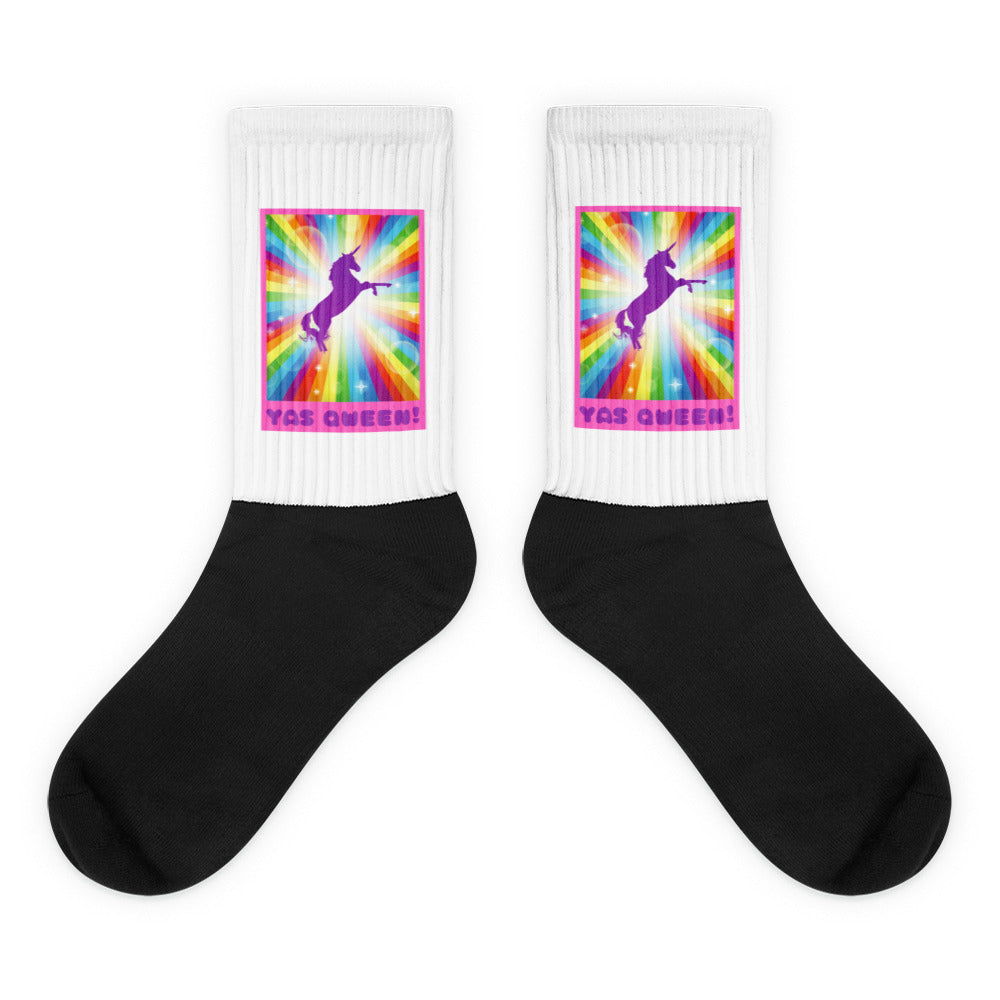 Pair of black-and-white socks with rainbow unicorn graphics and “YAS QWEEN!” text