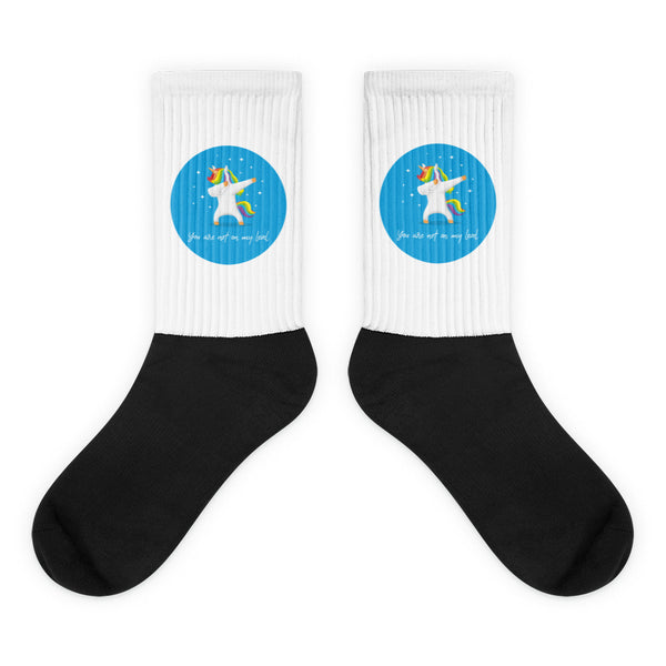 You Are Not On My Level Socks feature a dabbing unicorn within a turquoise circle on white, with a bold black foot, celebrating queer pride and self-expression.