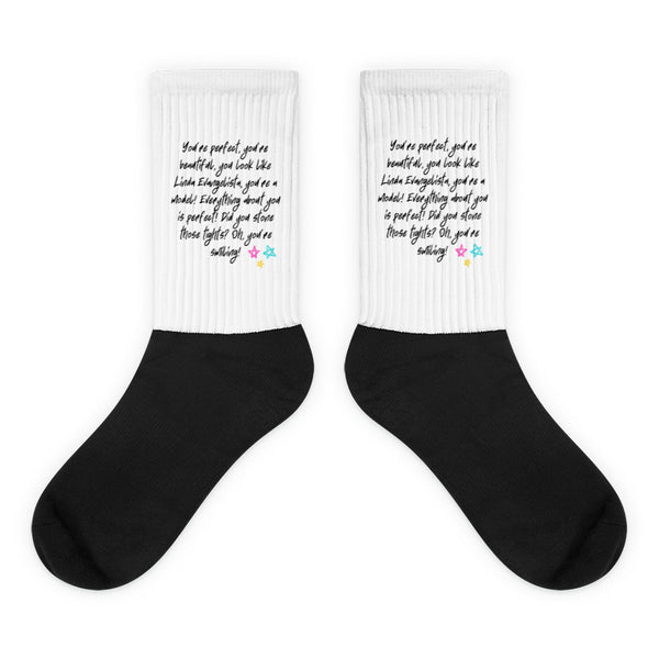 You Look Like Linda Evangelista Socks feature bold black foot, ribbed white leg with handwritten praise, and colorful stars; a sassy blend of comfort and pride, perfect for confident self-expression.