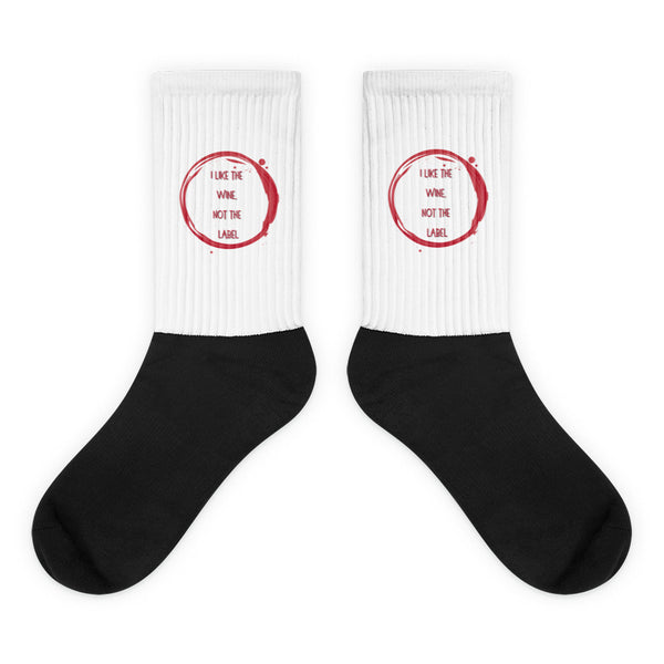 I Like The Wine Not The Label Pansexual Socks feature a bold black foot and a white leg with a red wine-stain graphic and slogan, celebrating queer pride and self-expression.