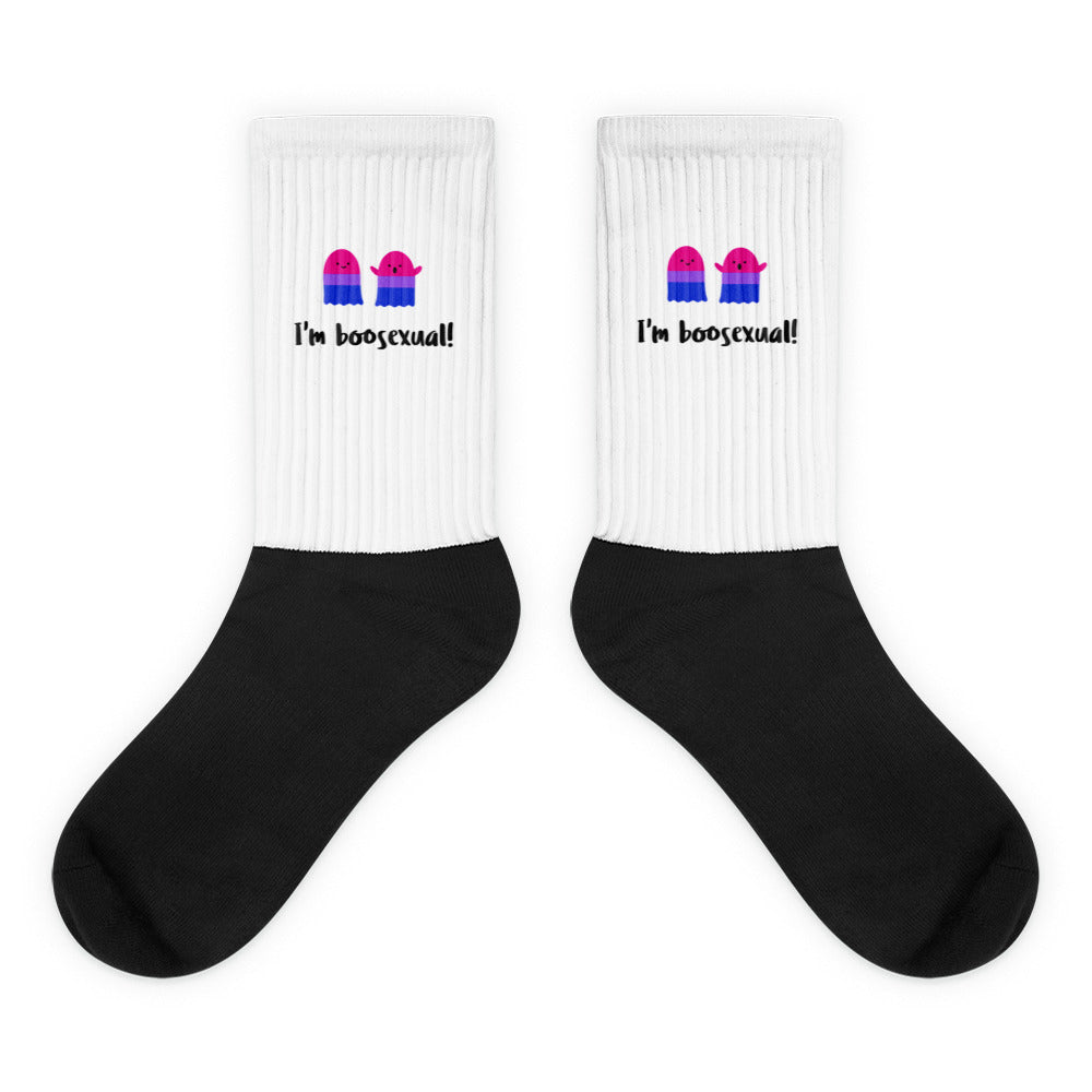 Pair of black-and-white socks with pink-blue ghosts and “I'm boosexual!” text